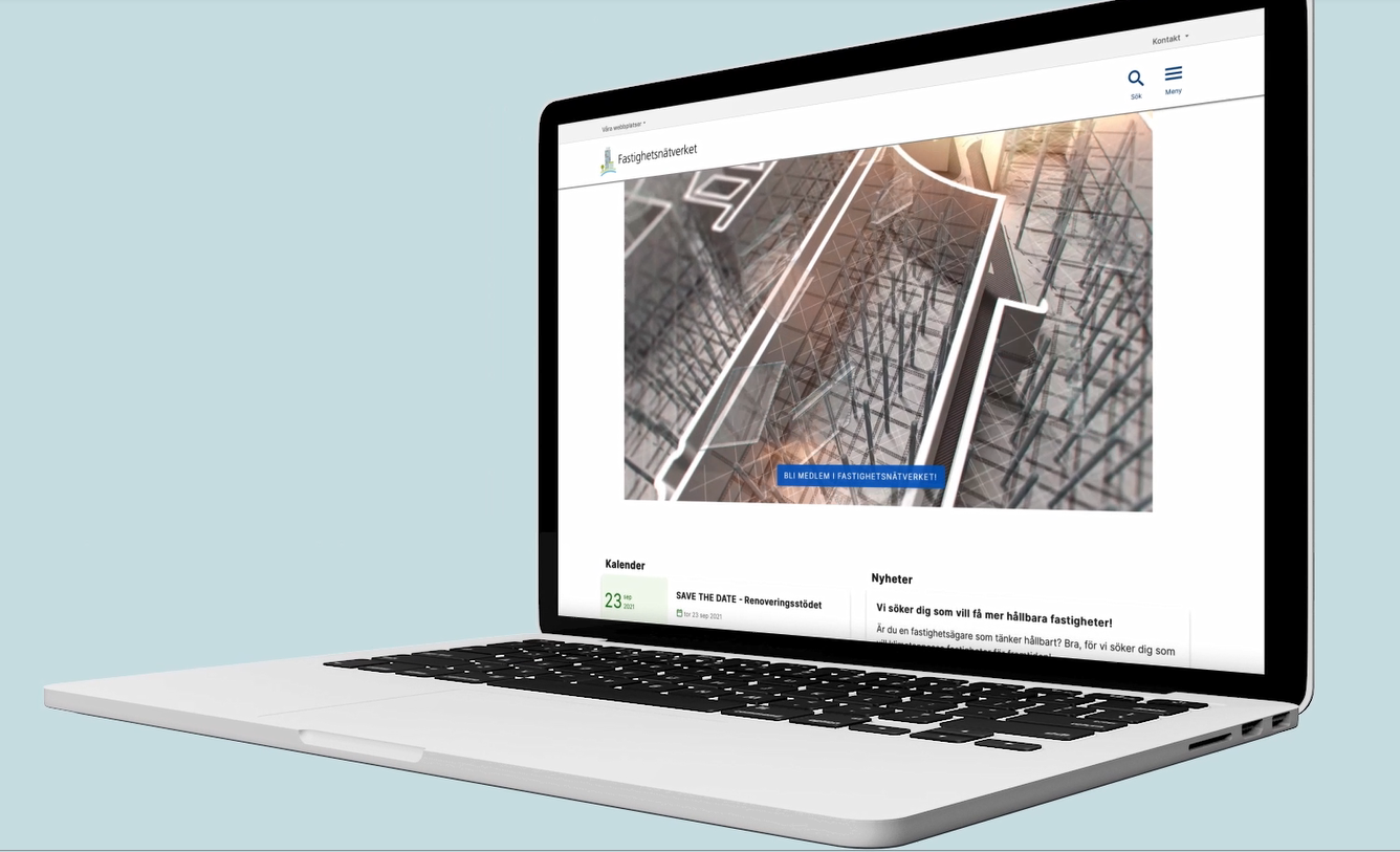 En laptop-dator med Fastighetsnätverkets webbplats på skärmen